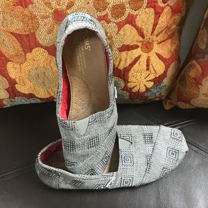 Grey and black Toms.